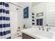 Bathroom featuring a shower with a blue and white striped curtain and vanity at 7540 E Pampa Ave, Mesa, AZ 85212