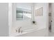 Bathroom with a large soaking tub and a window at 7540 E Pampa Ave, Mesa, AZ 85212