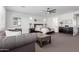 Main bedroom with a gray sofa, black furniture, and decor above the bed at 7540 E Pampa Ave, Mesa, AZ 85212