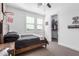 Bright bedroom boasts a rustic wood bedframe, natural light from shuttered windows, and a walk-in closet at 7540 E Pampa Ave, Mesa, AZ 85212