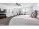 Bright main bedroom with large windows, neutral tones, and modern ceiling fan at 7540 E Pampa Ave, Mesa, AZ 85212