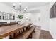 Dining area with a rustic wood table, wooden bench, and modern chandelier, perfect for Gathering gatherings at 7540 E Pampa Ave, Mesa, AZ 85212