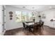 Cozy dining area with a rustic wood table and chairs, a view of the backyard, and natural light at 7540 E Pampa Ave, Mesa, AZ 85212