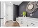 Hallway featuring a decorative shiplap wall, bench, and white storage cabinets at 7540 E Pampa Ave, Mesa, AZ 85212