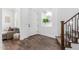 Bright entryway featuring wood-look tile flooring, a stylish mirror, and a staircase at 7540 E Pampa Ave, Mesa, AZ 85212