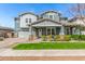 Charming two-story home featuring a welcoming front porch with stone accents and well-maintained landscaping at 7540 E Pampa Ave, Mesa, AZ 85212