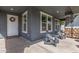 Inviting front porch with comfortable seating and charming stone accents on the columns at 7540 E Pampa Ave, Mesa, AZ 85212