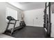 Home gym featuring a treadmill, weight rack, and mounted television at 7540 E Pampa Ave, Mesa, AZ 85212