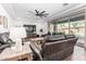 Bright living room featuring a ceiling fan, tile floors, and a large window showcasing a sparkling backyard pool at 7540 E Pampa Ave, Mesa, AZ 85212