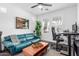 Living room with a green leather couch, foosball table, and natural light at 7540 E Pampa Ave, Mesa, AZ 85212