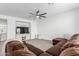 Cozy living room with modern ceiling fan, plush sectional sofa, and built in entertainment center at 7540 E Pampa Ave, Mesa, AZ 85212