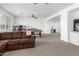 Bright living room featuring a foosball table, desk and neutral carpet at 7540 E Pampa Ave, Mesa, AZ 85212