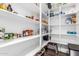 A well-organized pantry features adjustable shelving, providing ample space for storing a variety of food items at 7540 E Pampa Ave, Mesa, AZ 85212