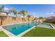 Gorgeous pool and spa with travertine surround and a water feature against a brick privacy wall at 7540 E Pampa Ave, Mesa, AZ 85212