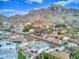 Expansive aerial view of a neighborhood with mountain backdrop and variety of home styles and lush greenery at 7542 N 22Nd Pl, Phoenix, AZ 85020