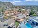 Bird's-eye perspective of residential area, showcasing diverse housing and a distant cityscape under blue skies at 7542 N 22Nd Pl, Phoenix, AZ 85020