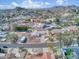 Aerial view of a house in a residential area, highlighting lush landscaping, mature trees and mountain views at 7542 N 22Nd Pl, Phoenix, AZ 85020