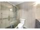 Modern bathroom features a glass enclosed shower with pebble floor and tiled walls at 7542 N 22Nd Pl, Phoenix, AZ 85020