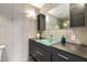 Bathroom with glass sink, modern lighting, and walk-in shower at 7542 N 22Nd Pl, Phoenix, AZ 85020