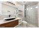 Modern bathroom with marble tile, frameless shower, vessel sink and illuminated mirror at 7542 N 22Nd Pl, Phoenix, AZ 85020