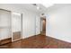 Bright bedroom with wood floors, skylight and sliding closet doors at 7542 N 22Nd Pl, Phoenix, AZ 85020