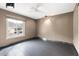 Bedroom with neutral walls, ceiling fan, tiled floors and large window with street view at 7542 N 22Nd Pl, Phoenix, AZ 85020