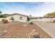 Charming single-story home featuring a bright blue door, desert landscaping, and an attached two-car garage at 7542 N 22Nd Pl, Phoenix, AZ 85020