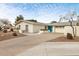 Beautiful single-story home with desert landscaping, a light-colored exterior, and a striking blue front door at 7542 N 22Nd Pl, Phoenix, AZ 85020