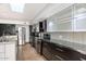 Bright kitchen featuring modern appliances, light countertops, dark lower cabinets and an island at 7542 N 22Nd Pl, Phoenix, AZ 85020