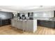 Modern kitchen with stainless steel appliances, a central island, sleek cabinets, and a bright skylight at 7542 N 22Nd Pl, Phoenix, AZ 85020