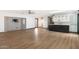 Bright living room with light wood floors, TV accent wall, and serving area with cabinets at 7542 N 22Nd Pl, Phoenix, AZ 85020