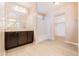 Bright bathroom featuring a large mirror, vanity with storage, and a tub/shower combination at 7769 W Bonitos Dr, Phoenix, AZ 85035