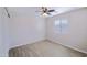 Bright, airy bedroom with tile flooring, a ceiling fan, a modern window shade, and minimalist design at 7769 W Bonitos Dr, Phoenix, AZ 85035