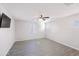 Bright, airy bedroom with tile flooring, a ceiling fan, natural light, and fresh design at 7769 W Bonitos Dr, Phoenix, AZ 85035