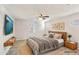 Staged bedroom with tile flooring, a ceiling fan, natural light, and modern, stylish decor at 7769 W Bonitos Dr, Phoenix, AZ 85035