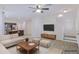 Staged living room showcases the open floor plan and natural light, with a tv and modern furniture at 7769 W Bonitos Dr, Phoenix, AZ 85035