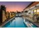 Inviting backyard pool area featuring a covered patio, outdoor dining, and lush landscaping at 8319 E Columbus Ave, Scottsdale, AZ 85251