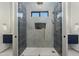 Modern bathroom featuring a glass enclosed shower with stylish tilework and bronze fixtures at 8319 E Columbus Ave, Scottsdale, AZ 85251