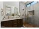 Modern bathroom featuring double vanity, wood-look tile accents, and glass shower at 8319 E Columbus Ave, Scottsdale, AZ 85251