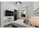 Cozy bedroom featuring a ceiling fan, TV, closet and modern decor at 8319 E Columbus Ave, Scottsdale, AZ 85251