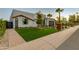 Stylish home with green grass, desert landscaping, and a sleek exterior design, perfect for modern living at 8319 E Columbus Ave, Scottsdale, AZ 85251