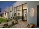 Inviting front entrance featuring a glass door, desert landscaping, and stylish outdoor seating at 8319 E Columbus Ave, Scottsdale, AZ 85251