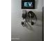 EV charging unit mounted on the wall in a three car garage at 8319 E Columbus Ave, Scottsdale, AZ 85251