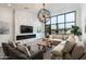 Bright living room with an electric fireplace, large windows, and inviting seating areas at 8319 E Columbus Ave, Scottsdale, AZ 85251