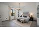 Bright main bedroom featuring modern chandelier, neutral tones, and comfortable seating bench at 8319 E Columbus Ave, Scottsdale, AZ 85251