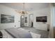 Spacious bedroom featuring tile floors, white dresser, and elegant light fixture at 8319 E Columbus Ave, Scottsdale, AZ 85251