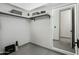 A view of a large walk-in closet featuring built-in shelves and modern accents at 8319 E Columbus Ave, Scottsdale, AZ 85251