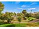 Serene view of community landscape with lush trees, walking path, and tennis courts at 9125 E Purdue Ave # 214, Scottsdale, AZ 85258