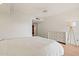 This bright main bedroom features white furniture and hardwood floors at 9125 E Purdue Ave # 214, Scottsdale, AZ 85258