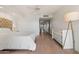 Bright main bedroom with a plush upholstered headboard, ceiling fan, and wooden floors at 9125 E Purdue Ave # 214, Scottsdale, AZ 85258